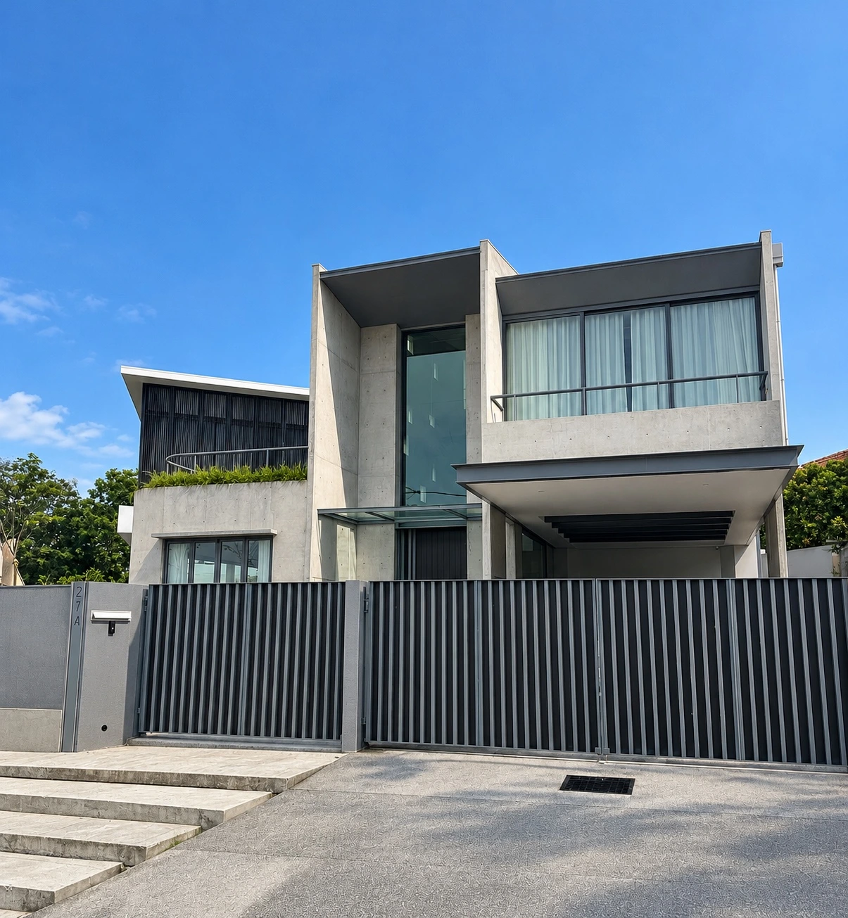 Front elevation with concrete walls, glazed entrance and sheltered carport