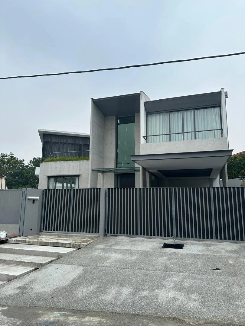 Street view of the concrete facade and front gate