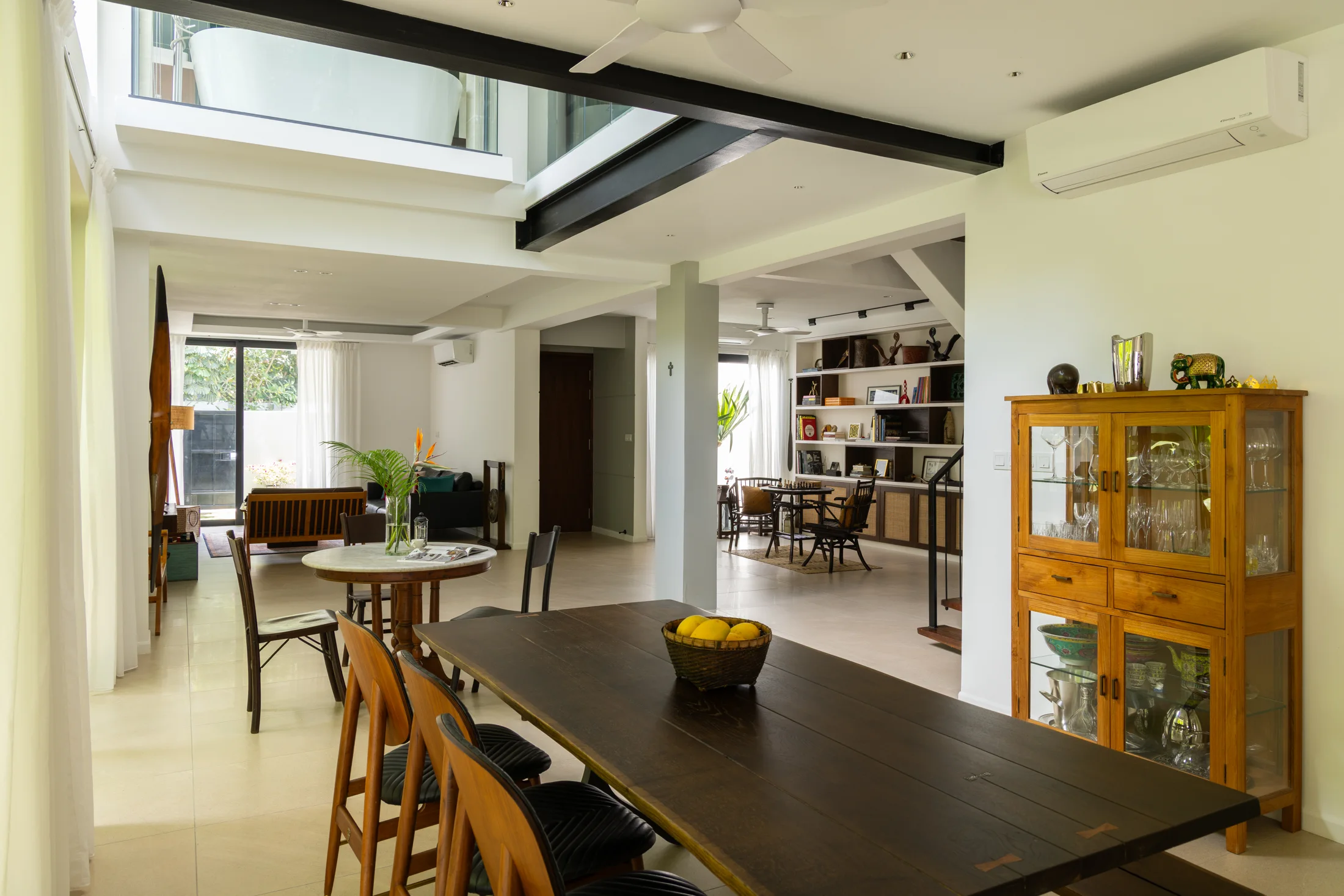 Dining space beneath a double-height ceiling