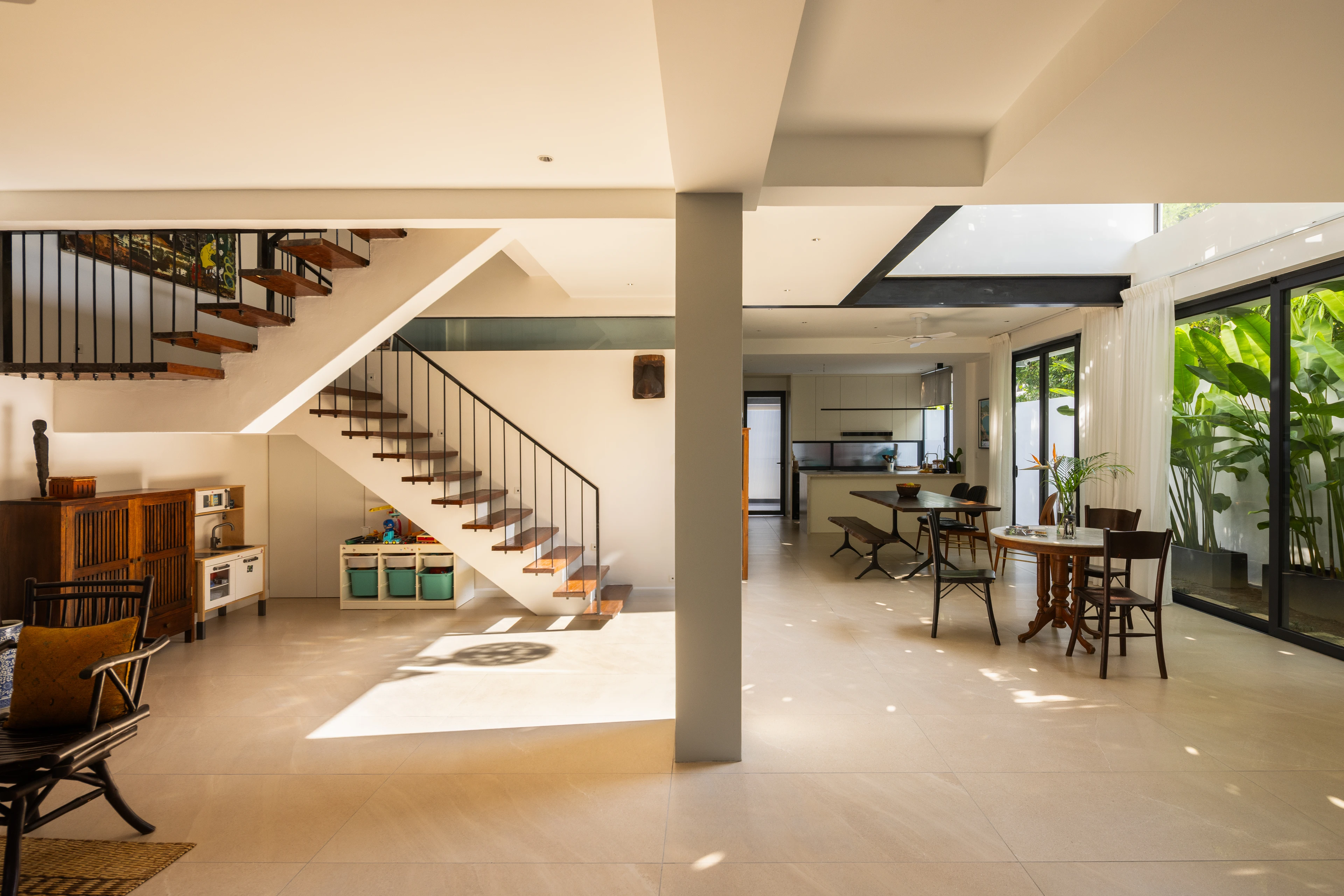 Staircase and shared living spaces opening to the garden