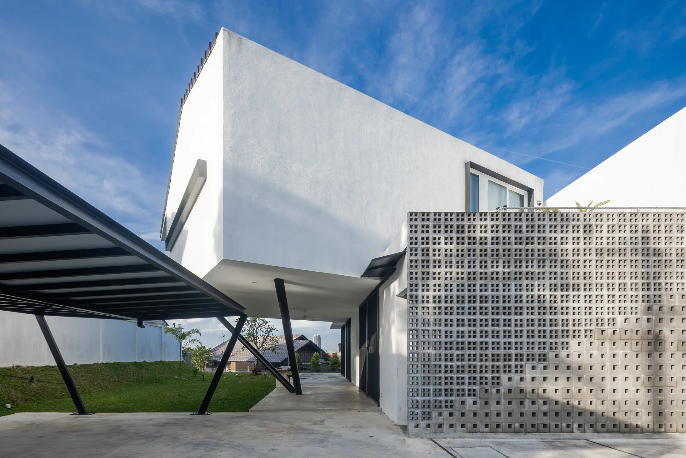 Concrete screen and white facade