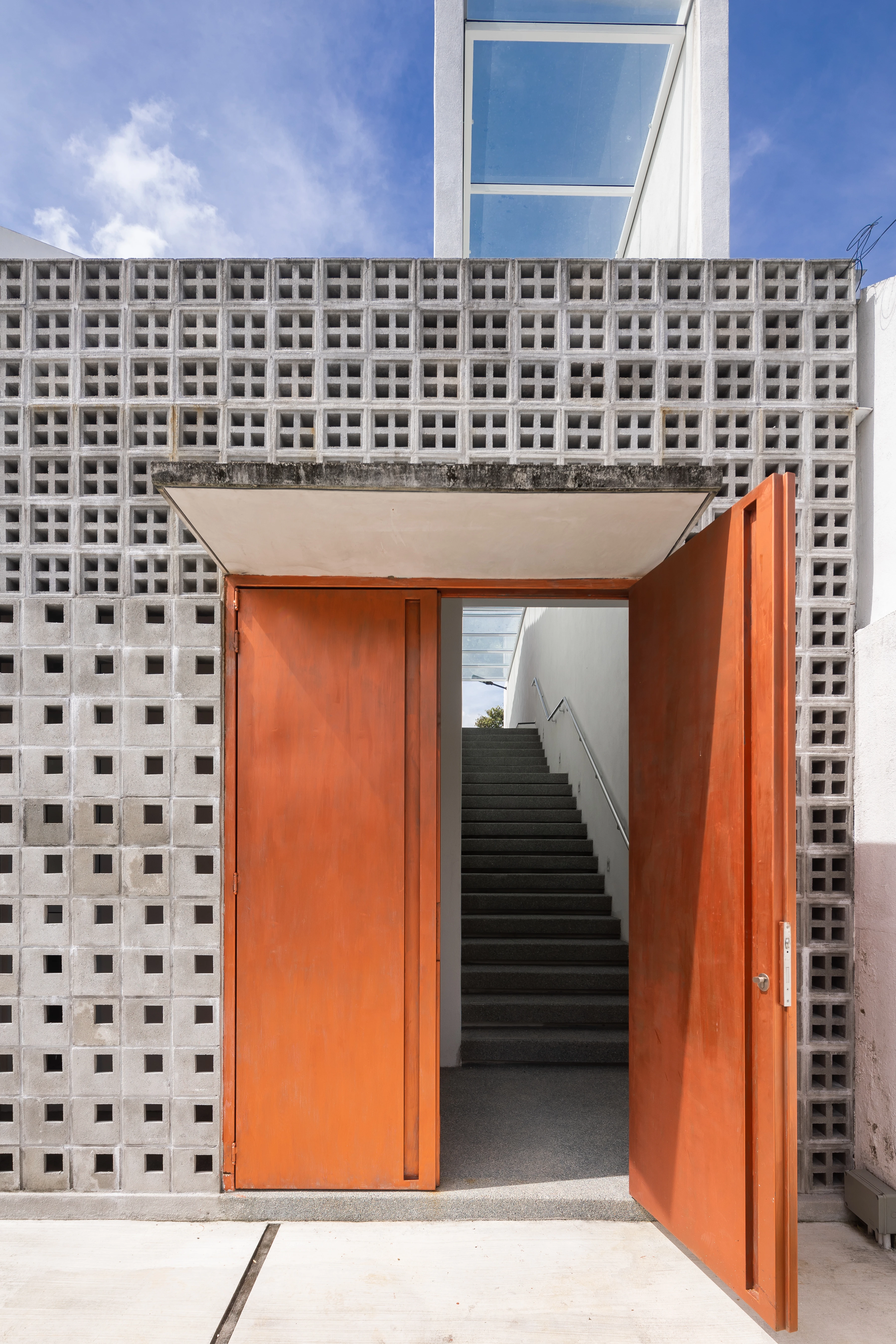 Orange entrance framed by concrete blocks