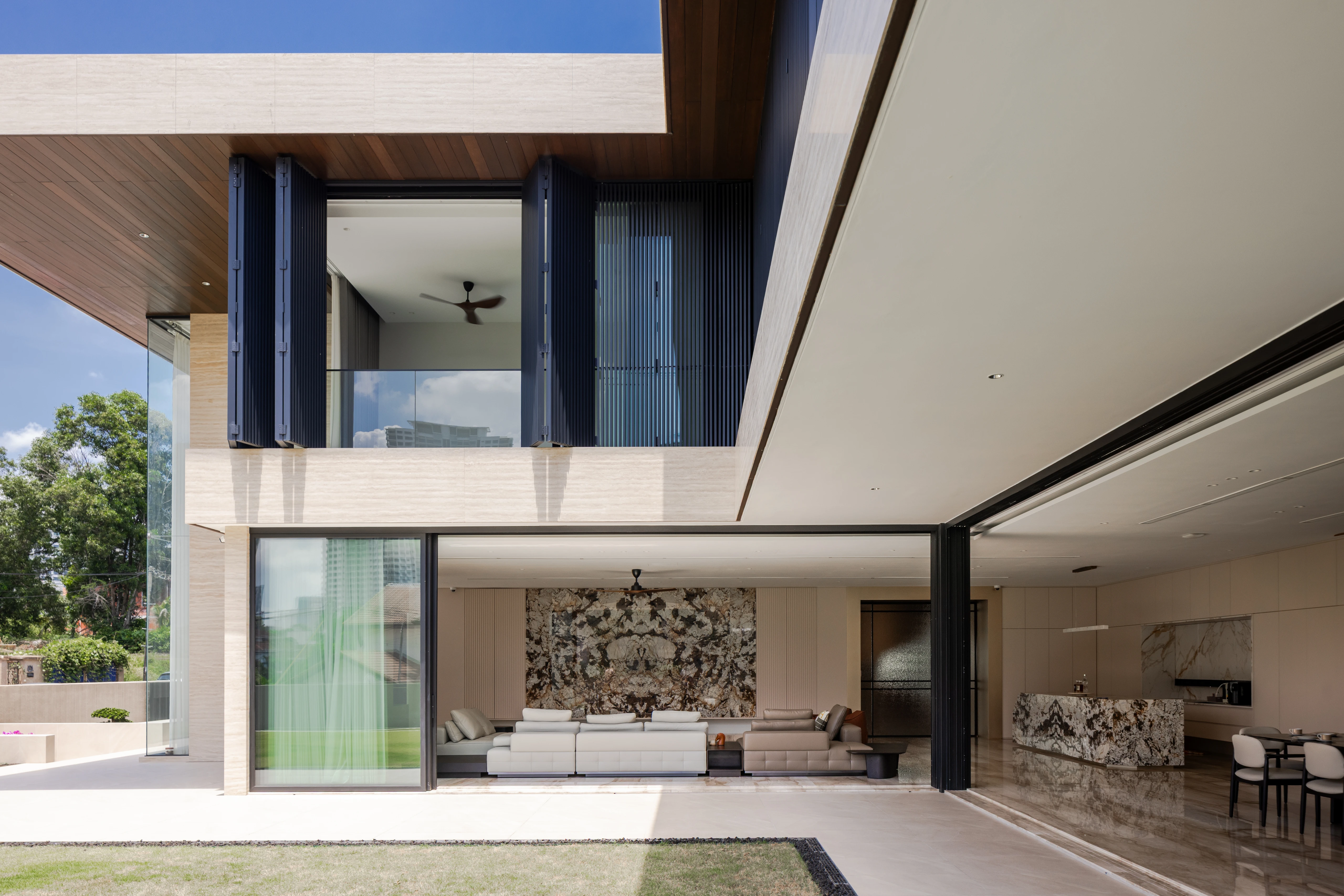 Poolside living beneath a deep roof overhang