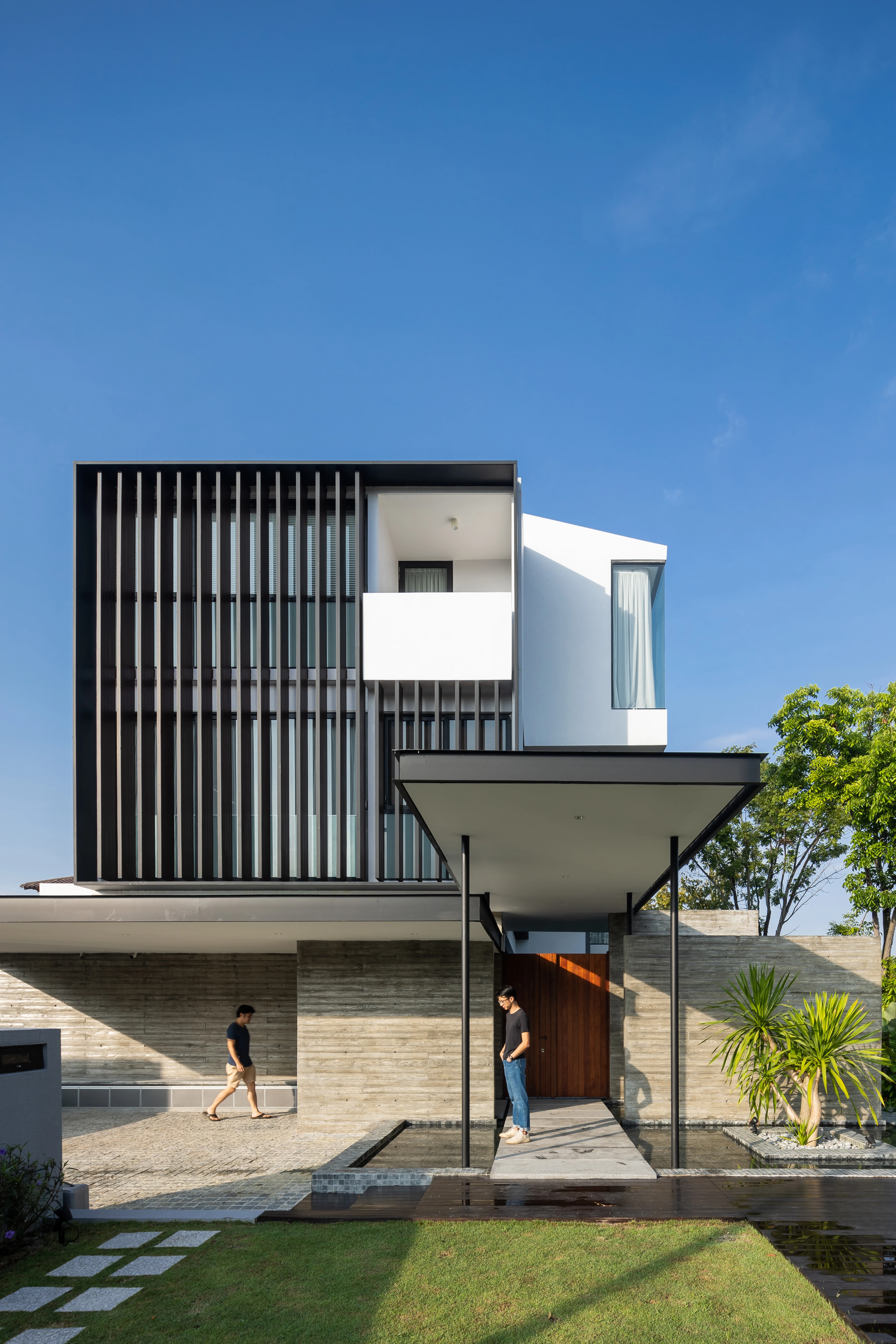 Front elevation with vertical screens and sheltered carport