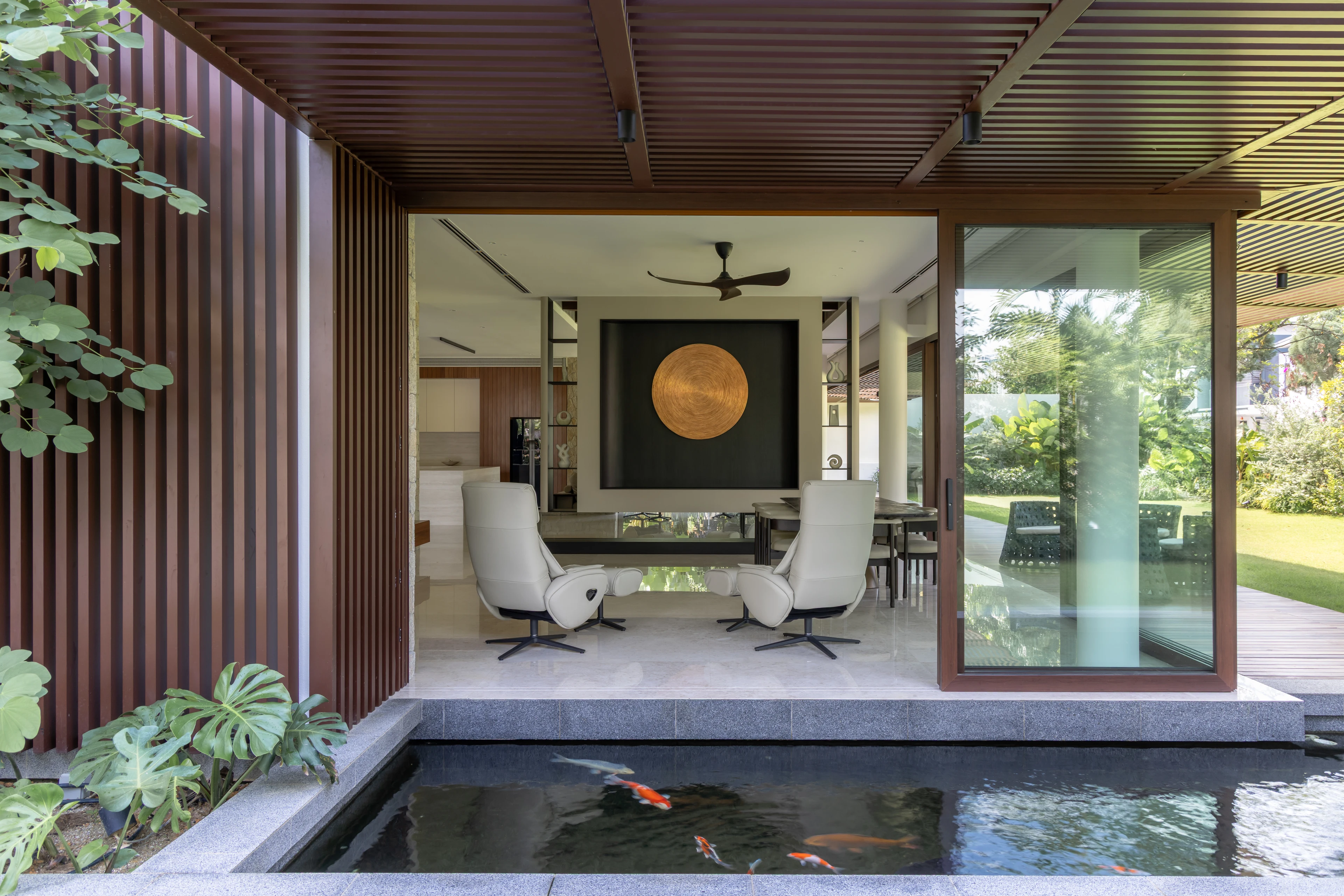 Living space beside a planted edge and reflecting pond