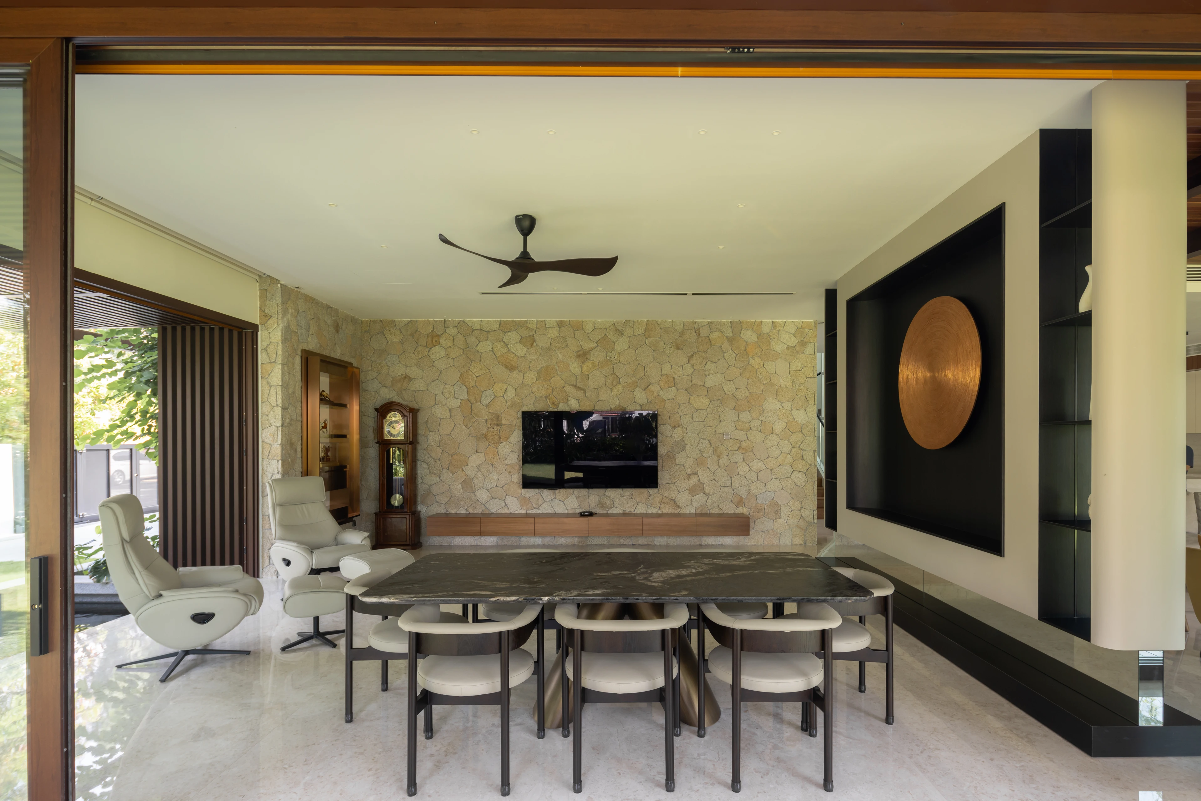 Dining area with a stone wall and circular artwork