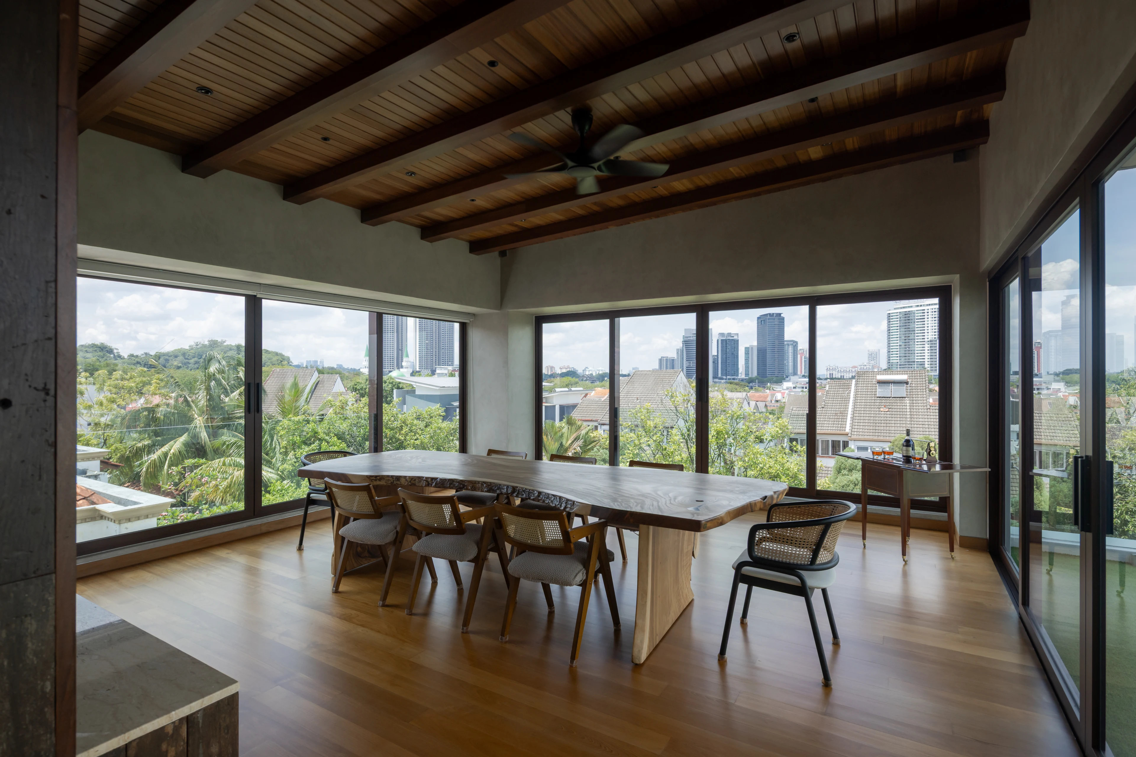 Upper-floor living and dining spaces with garden views