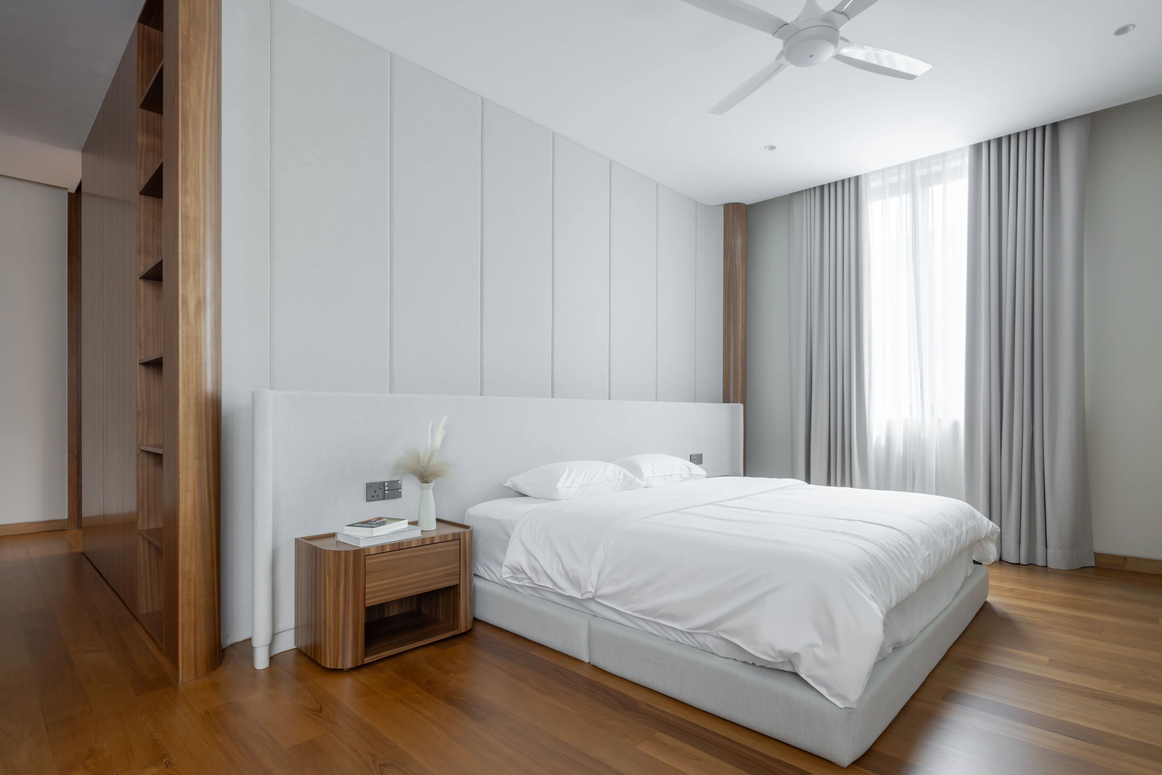 Bedroom with timber flooring and full-height curtains