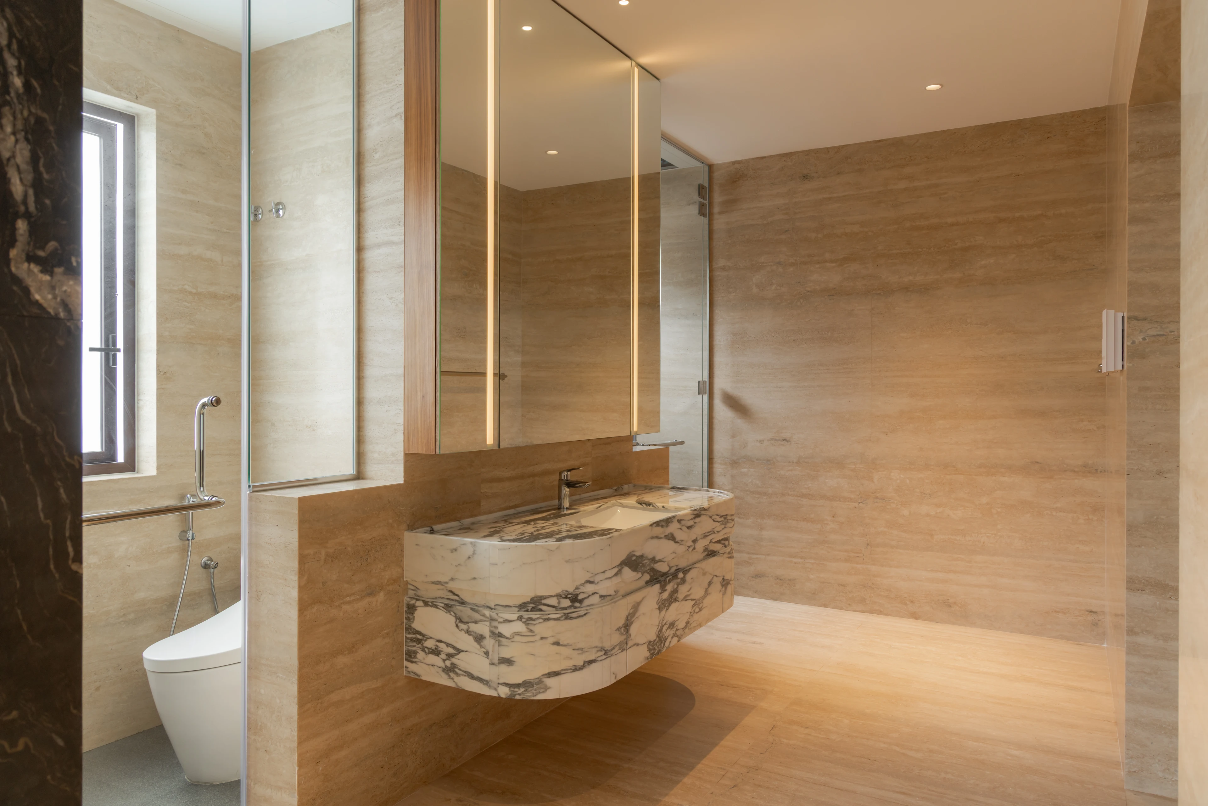 Stone bathroom with a sculptural marble basin