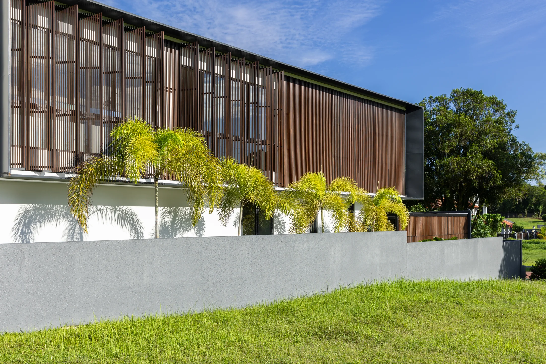 Timber screens above a stone garden wall
