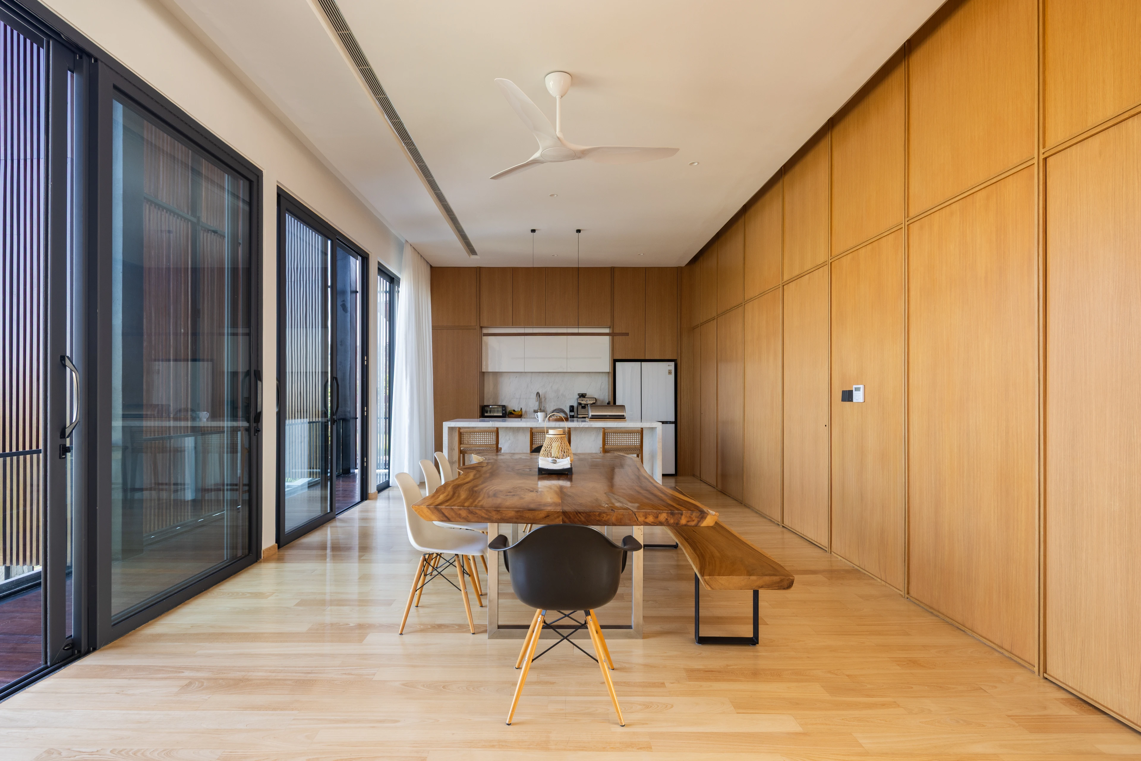 Living spaces along a timber-lined wall